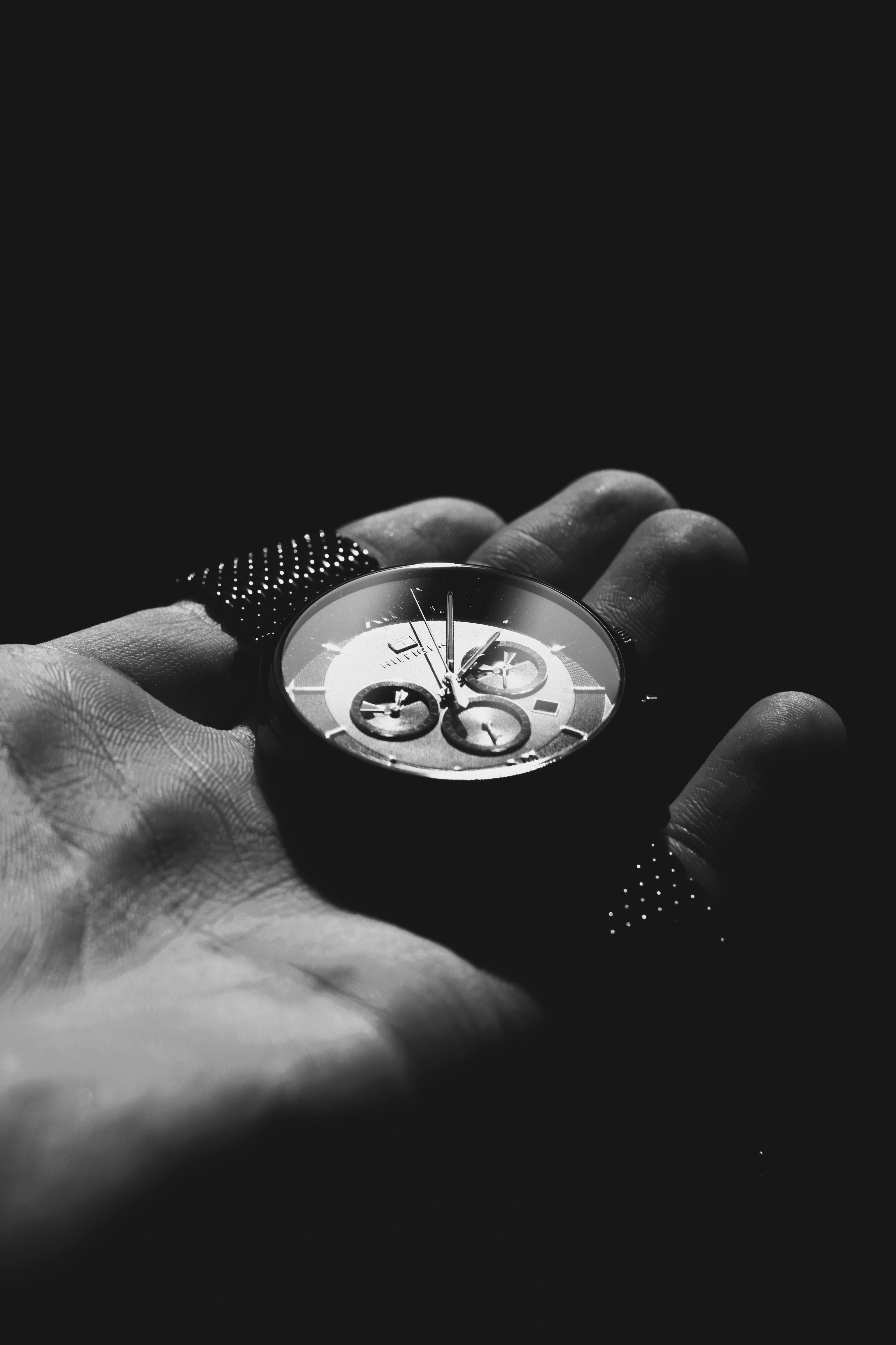 silver and black round chronograph watch